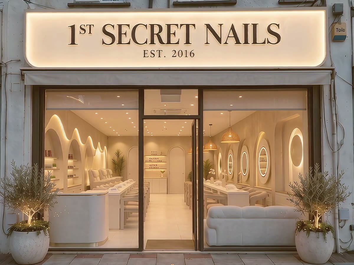 The 1st Secret Nails shopfront on Well Hall Road, Eltham, lit at dusk