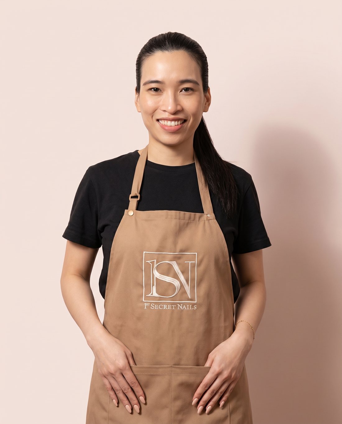 Leanne, founder of 1st Secret Nails, in her salon apron