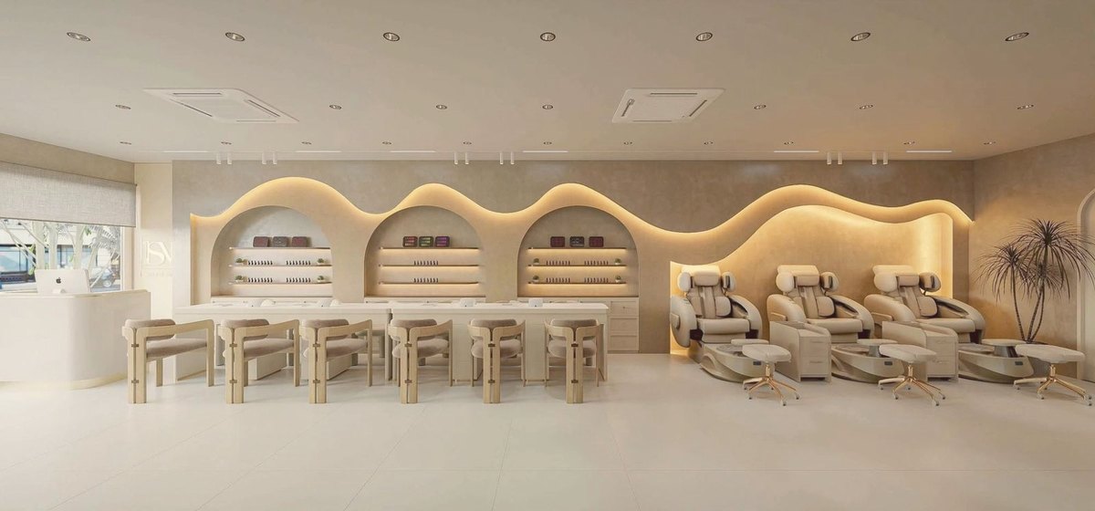 The nail bar and pedicure chairs along one lit wave wall
